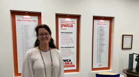 YWCA Spokane CEO Janine Wynne stands in building atrium. 