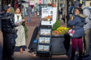  A woman shares Jehovah's Witnesses' literature with a passerby on a street corner