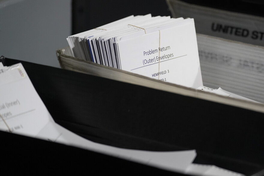 FILE - A bundle of mail-in ballots marked "Problem Return, (Outer) Envelopes" are set aside as election workers continue counting ballots for the Pennsylvania primary election, Wednesday, May 18, 2022, at the Mercer County Elections Board in Mercer, Pa.