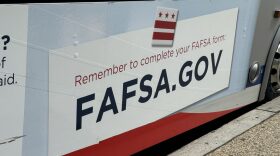 A sign reminding people to complete the Free Application for Federal Student Aid — better known as FAFSA — appears on a bus near Union Station in Washington, D.C.