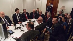 In this image provided by the White House, President Donald Trump receives a briefing on the Syria military strike from his National Security team after the strike at Mar-a-Lago in Palm Beach, Fla. (White House via AP)