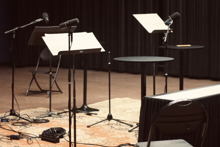 Podiums and microphones stand in a recording space with no people.