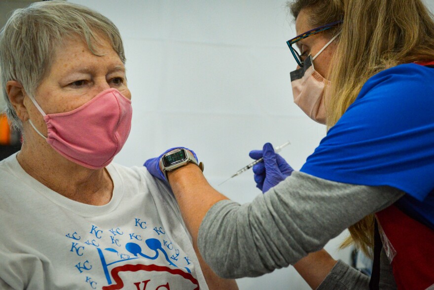 Karla Hunt, a registered nurse with the Platte County Health Dept., vaccinates Phyllis McCaslin, 73, during a mass vaccination clinic in Riverside on Tuesday morning.