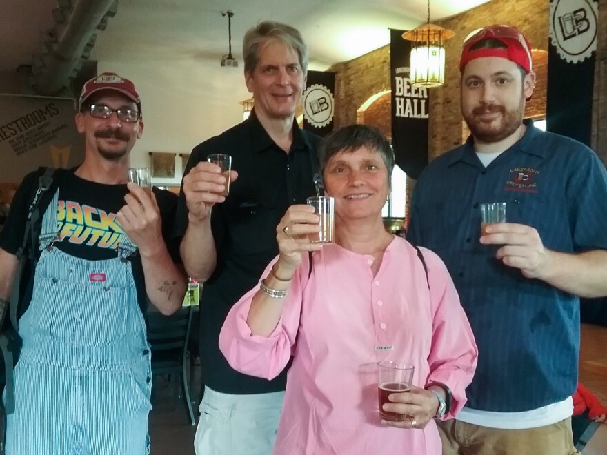 Archaeologist Bettina Arnold (center) and her team uncovered the cauldron containing remnants of the ancient alcoholic beverage. She teamed up with Lakefront Brewery in Milwaukee to re-create the recipe. Mike Vergolina (from left), Russ Klisch, Arnold and Chad Sheridan toast with the finished product, a braggot based on a 2,500-year-old recipe.