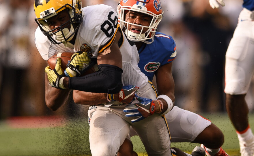After catching a 45-yard pass in the second half, Michigan wide receiver Jehu Chesson (86) is immediatley brought down by Florida cornerback Vernon Hargreaves III (1). (Greenberry Taylor/WUFT News).