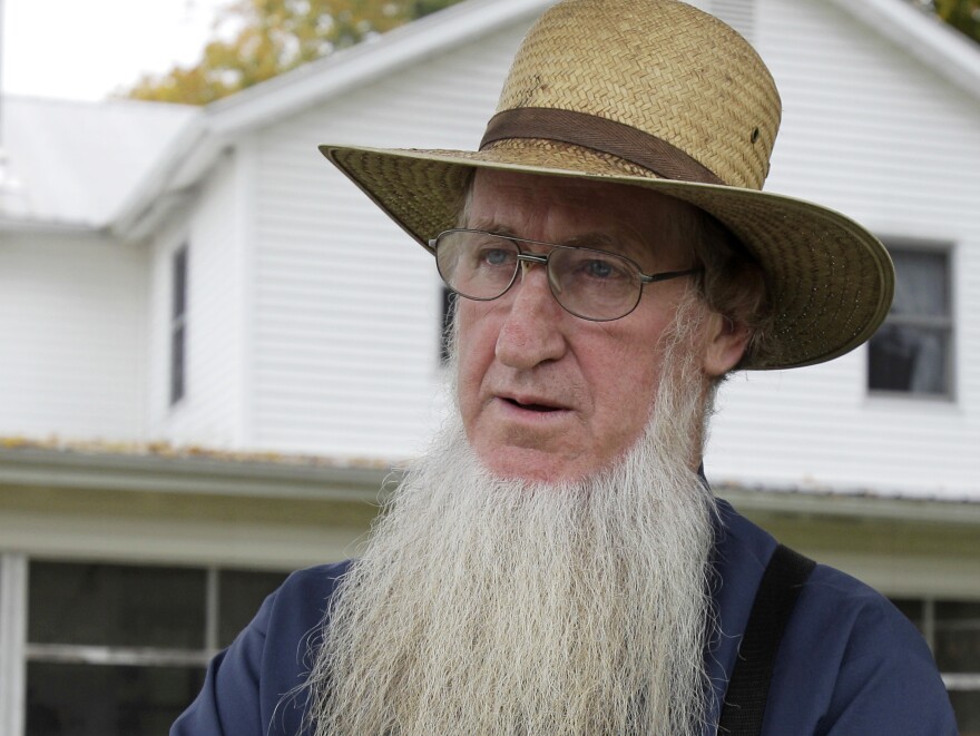 Sam Mullet stands in the front yard of his home in Bergholz, Ohio, in 2011. Mullet has now been sentenced to serve 10 years and nine months in jail.