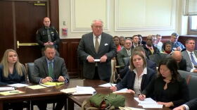 Defense attorney R. Scott Croswell speaks with the accused Cincinnati council members behind him. 