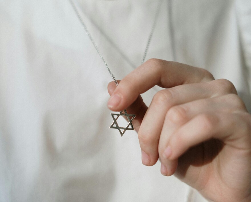 A woman wears a Star of David.