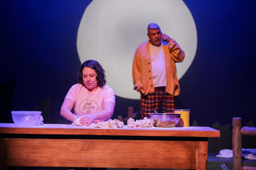 Bea (played by Ashely Alvarez) kneads dough on stage. The play centers around Bea's decision to move to rural Maine and open a bakery.