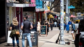 Some people wear masks outside businesses on South Congress Avenue on March 3. 