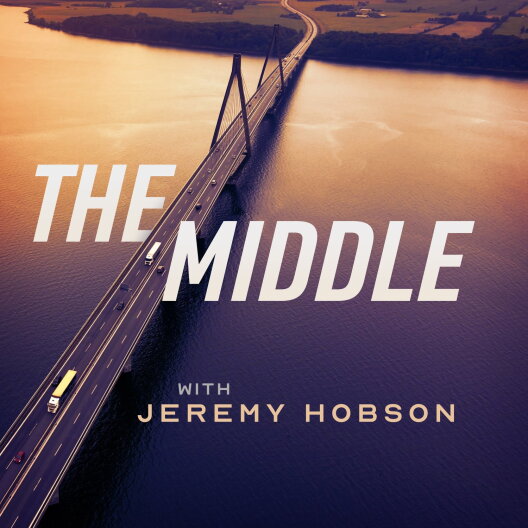 A highway bridge bisects an orange-brown body of water.