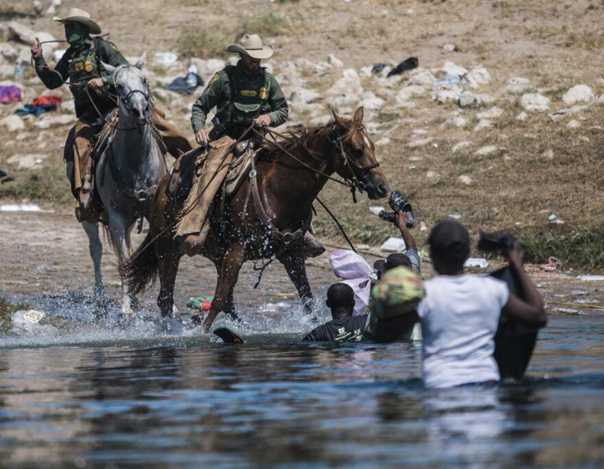  TRUMP-FEELING MOMENT Horse-mounted U.S. Border Patrol agents drive back asylum-seeking Haitian migrants on the bank of the Rio Grande at Del Rio, Texas, last weekend.