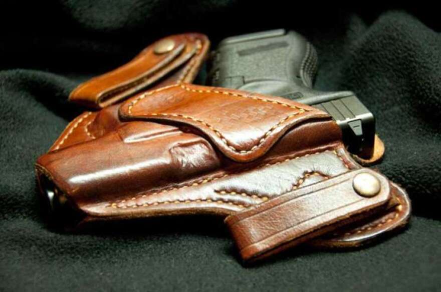 A gun sits in a holster.