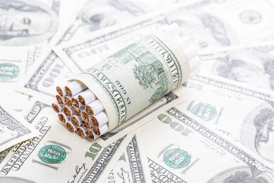 tobacco money Open Pack of Cigarettes Isolated on a White Background Stock Photo teaching people of all ages about the expense of smoking Tobacco Is a Waste of