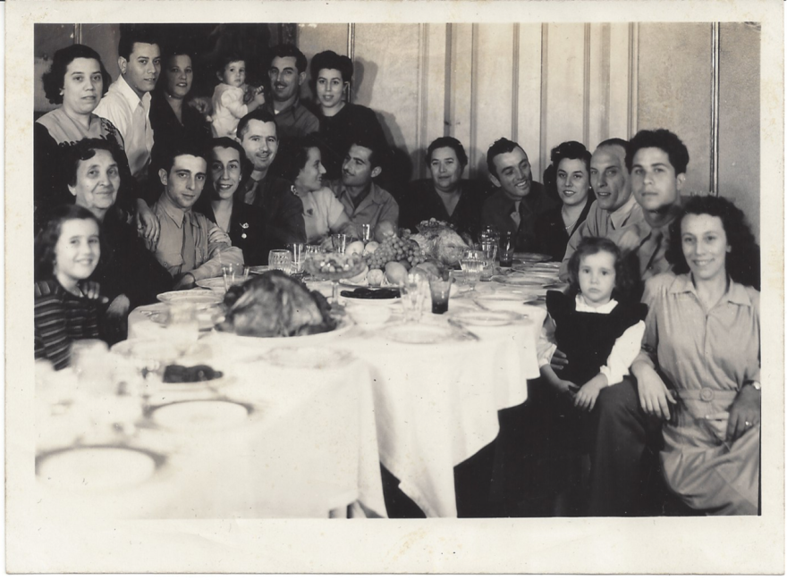 "Italian POWs and local Sicilian women at Thanksgiving dinner."