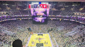 A packed Chase stadium in all violet surrounding the basketball court with the Valkyries vs the Dream on the jumbotron.