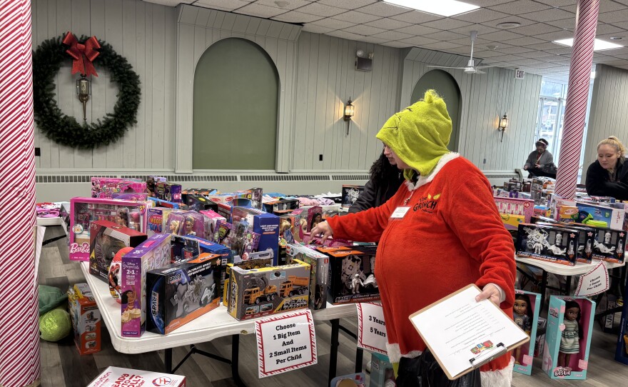 Trish Smith helps a "shopper" find gifts.