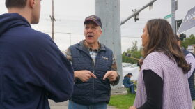 Sen. Dan Sullivan, R-Alaska, talks to staffers on the morning of Aug. 18, 2026, at the intersection of the Seward Highway and Northern Lights Boulevard. The Midtown Anchorage intersection is a favored spot for candidate sign-waving, and Sullivan, who is running for re-election, was there with U.S. Rep. Nick Begich, R-Alaska, also running for re-election.