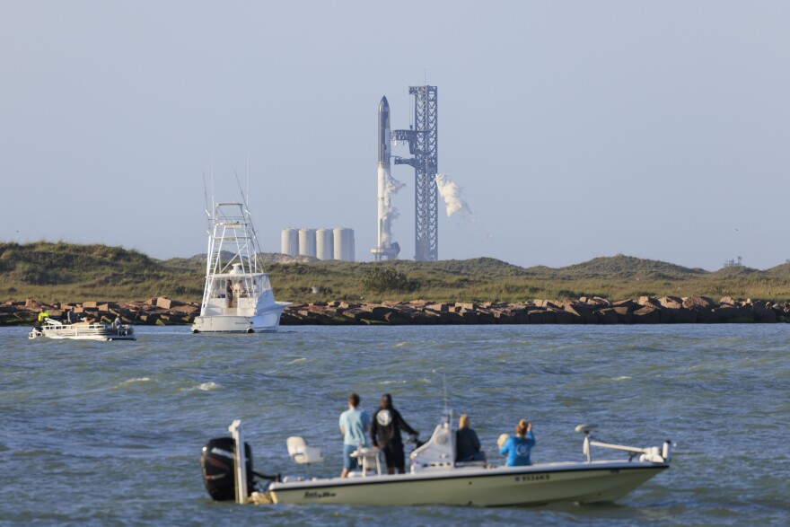 SpaceX's Starship, the largest rocket ever built, atop the launch pad at their Boca Chica Beach facility seen from Isla Blanca Park at South Padre on April 17, 2023. Thousands gathered at Isla Blanca Park anticipating the launch, but SpaceX scrubbed it shortly before takeoff and expect to re-attempt in the coming days.