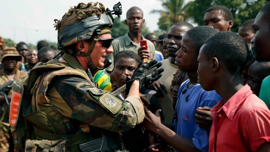 A French soldier talks to a crowd outside a church in Bangui, capital of the Central African Republic, on Thursday.