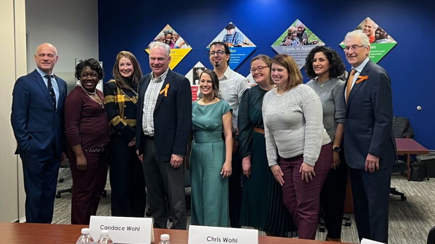 U.S. Sen. Tim Kaine poses with attendees during a roundtable in Norfolk Tuesday. (Photo by Laura Philion)