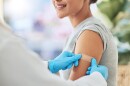Band aid, vaccine or injection for covid and global virus in security, safety or wellness insurance. Doctor hands, medical employee or healthcare worker with plaster for happy or smile hospital woman.