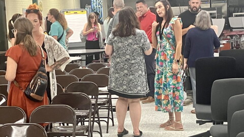 Parents of Pekin District 108 students chat Monday after a special school board meeting in the Washington Intermediate School cafeteria.
