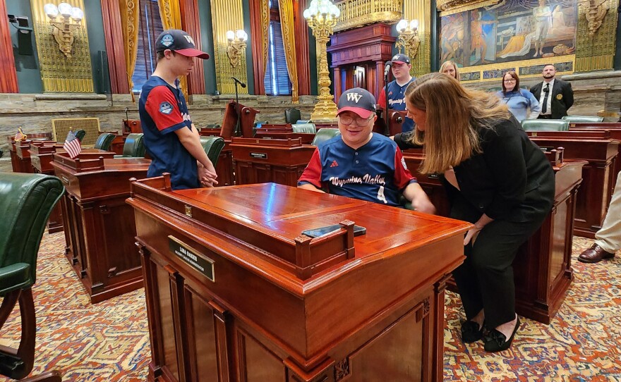 Wyoming Valley Challenger teammate Jacob Canfield sits at the desk of Sen. Lisa Baker.