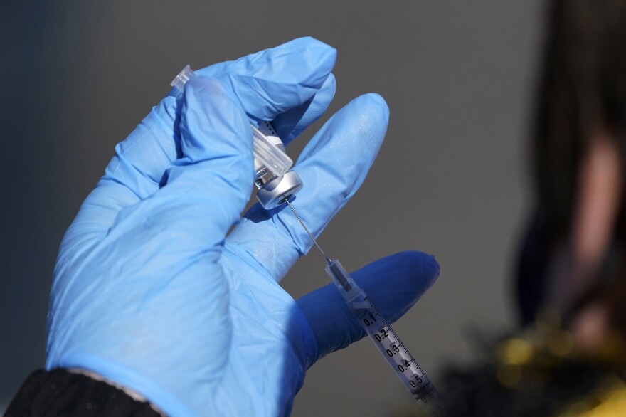 A nurse fills a syringe with COVID-19 vaccine at a mass vaccination site in Kansas City, Mo. on March 19, 2021.
