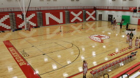 A floor at a school gym with a Native American image for a logo