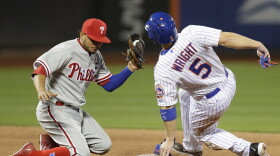 Philadelphia Phillies shortstop Freddy Galvis has the ball but the New York Mets' David Wright is safe on an eighth-inning stolen base in New York on Tuesday.