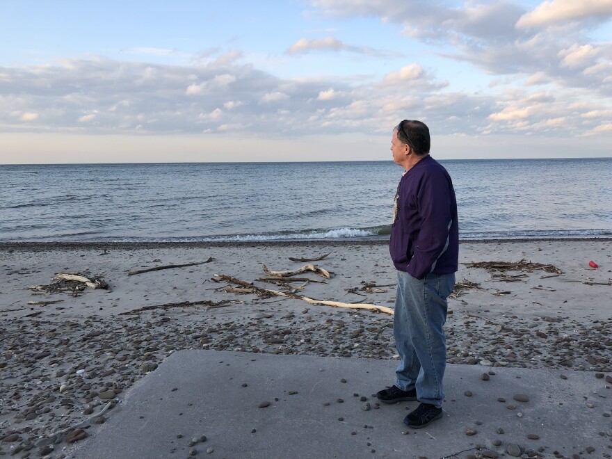 Bobby Jones stands on the site of his old patio, which is now partially buried by last year's floods.