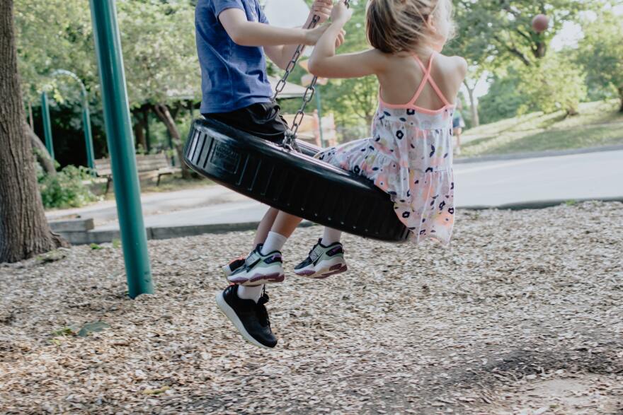 Children playing on a swing