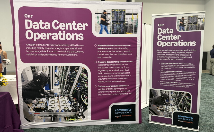 A large banner reads "Our Data Center Operations." The text is in white while the rest of the banner is mostly purple. A large square banner takes up most of the photo. A smaller, rectangular banner is to the right of the larger one. Both banners have the same text. 
