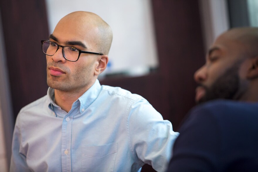 Ramon De Jesus, program manager for diversity development at Cambridge Public Schools with Cambridge Rindge and Latin history teacher Kevin Dua. (Jesse Costa/WBUR)