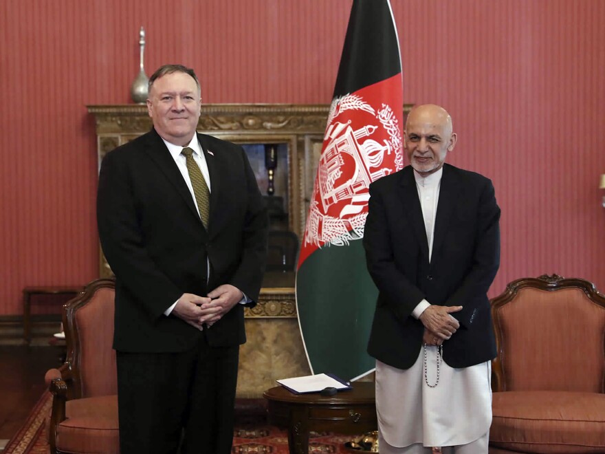 Secretary of State Mike Pompeo, left, stands with Afghan President Ashraf Ghani, at the Presidential Palace in Kabul, Afghanistan, on Monday. Pompeo says the U.S. will cut $1 billion in aid to Afghanistan. [Afghan Presidential Palace via AP]