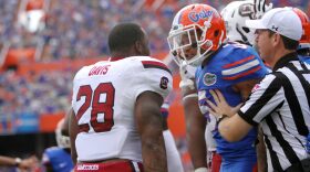 After having his helmet ripped off during the previous play, South Carolina’s Mike Davis and Florida’s Jalen Tabor exchange words.