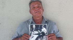 Juan Romero earlier this year at his home in Modesto, Calif., holding a photo of himself and Sen. Robert F. Kennedy, taken by The Los Angeles Times' Boris Yaro on June 5, 1968. Romero died this week at age 68. CREDIT: Jud Esty-Kendall/StoryCorps
