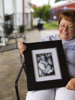 Lisa Hobbs holds a picture of her husband, Gene "Pius" Hobbs. Hobbs was raking gravel with the Meade County public works crew when a dump truck backed over and killed him.
