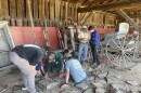 Kevin Fife, a professional stone mason, leads students at Canterbury Shaker Village through the basics of building an old-fashioned dry stack stone wall. The class is part of the New Hampshire Preservation Alliance's Career Exploration in the Old Building Trades program.