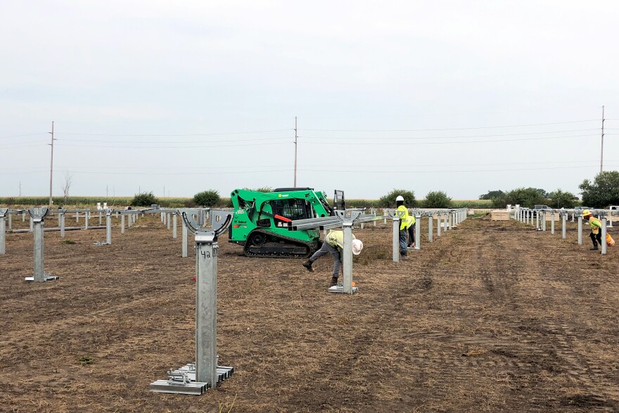 Workers prepare eight acres of a what would have been a corn field for a solar farm that is set to be operational by the end of 2019 in Kentland, IN.