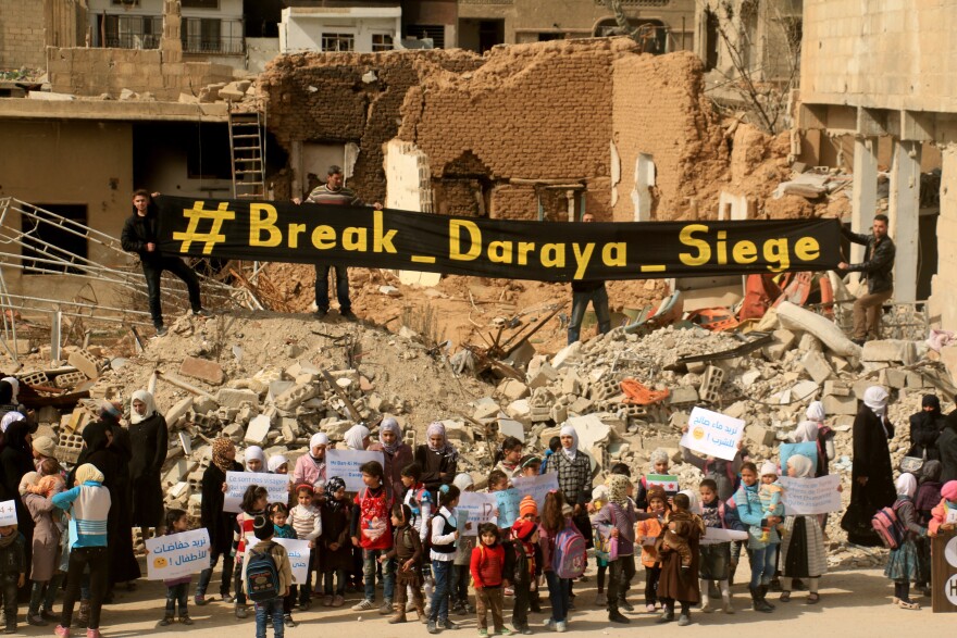 Syrian women and children stage a protest against the government's siege of Daraya, outside Damascus, on March 9. The protesters demanded that President Bashar Assad's government allow humanitarian aid into the city.