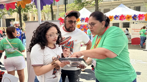 An El Pueblo volunteer helping register a voter at Fiesta del Pueblo, a festival El Pueblo organized in downtown Raleigh on Sept. 20, 2026.