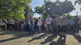 People stand at the front of the crowd gathered during a protest on June 11, 2025 outside the Lane County Courthouse.