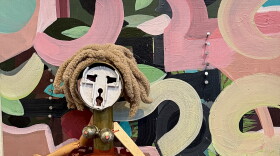 Female figure made of vegetable steamer skirt, bone legs and Barbie boot