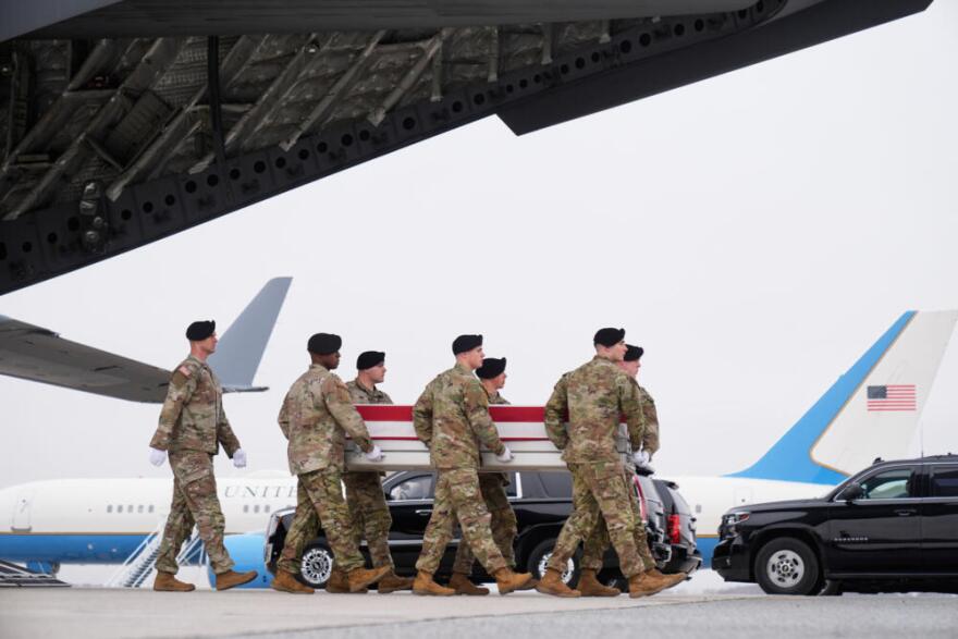An Army carry team moves a flag-draped transfer case with the remains of U.S. Army Reserve soldier Chief Warrant Officer 3 Robert Marzan, 54, of Sacramento, Calif., who was killed in a drone strike at a command center in Kuwait after the U.S. and Israel launched its military campaign against Iran, during a casualty return, Saturday, March 7, 2026, at Dover Air Force Base, Del. (Mark Schiefelbein/AP)