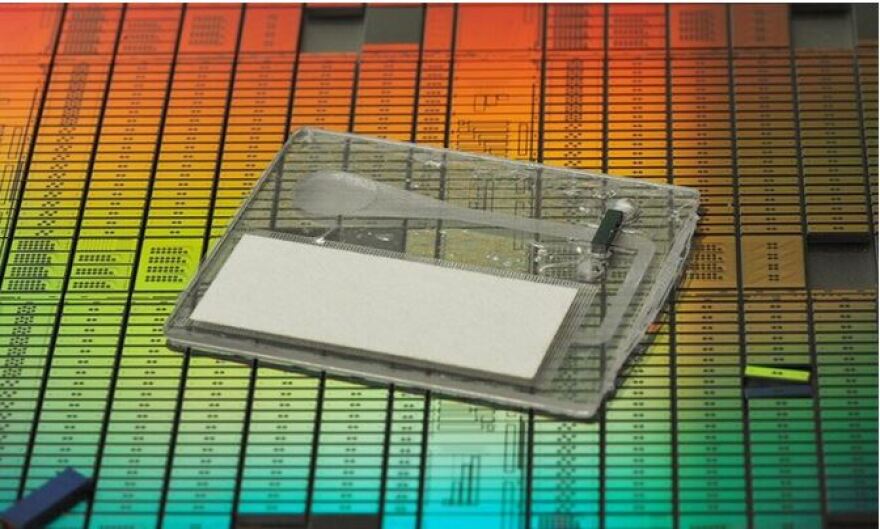 A photonic chip on a multicolored background.