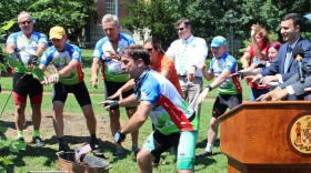 Cyclists on the Tour de Trees bicycling tour plant a tree in Washington, D.C.