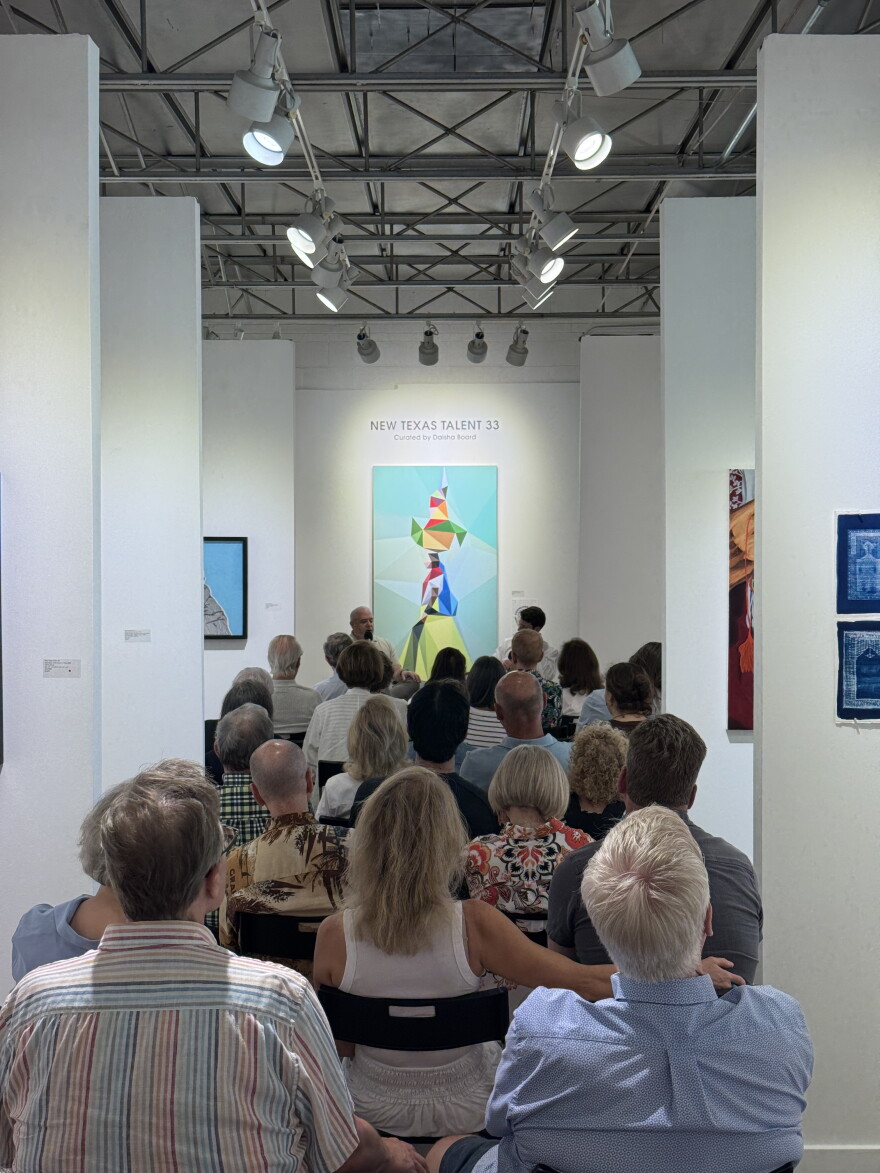 Guests listen to a talk between gallerists Steve Green and William Bardin about the transition from Craighead Green Gallery to Bardin Gallery.