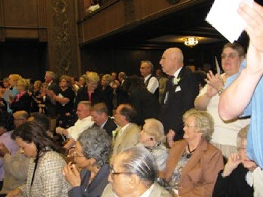 A full house at the city council chamber gives Mayor Mark Funkhouser and the new city council a standing ovation.